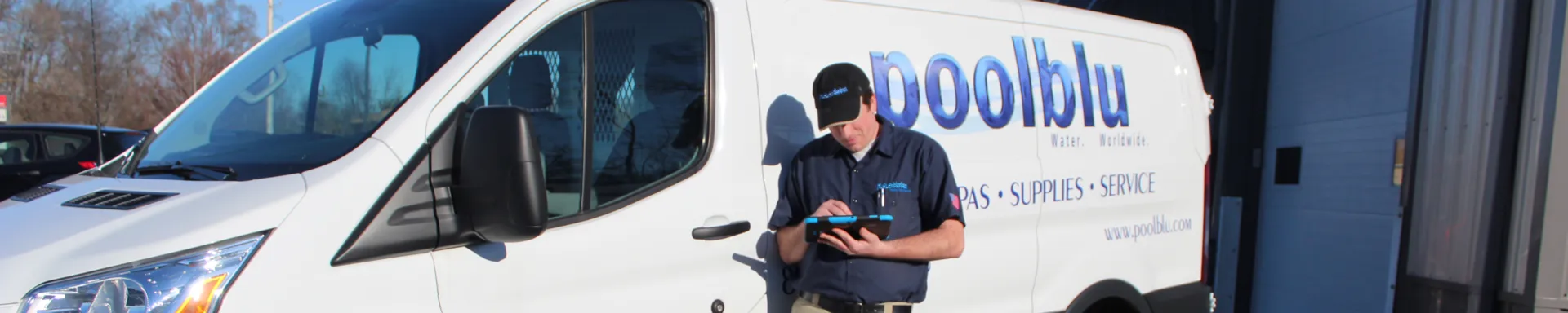 A Poolblu technician stands beside a branded service van, ready for an on-site visit.